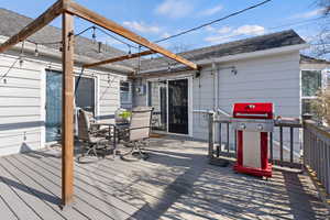Wooden deck with outdoor dining area and grilling area
