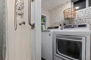 Washroom with washer and clothes dryer