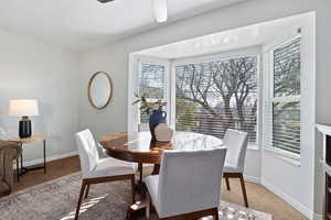 Dining room with carpet flooring and a ceiling fan