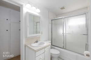 Full bathroom with vanity and shower / bath combination with glass door