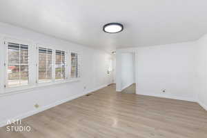 Unfurnished room featuring baseboards and light wood-style flooring