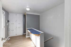 Foyer entrance with light wood-style flooring and baseboards