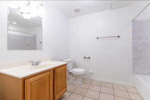 Bathroom with vanity, light tile patterned flooring, and  shower combination