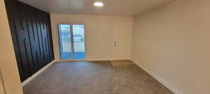 Carpeted spare room with baseboards