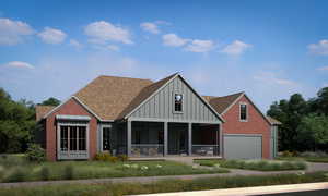 View of front facade featuring board and batten siding, a porch, roof with shingles, brick siding, and an attached garage