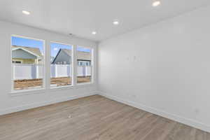 Spare room featuring light wood-type flooring and recessed lighting