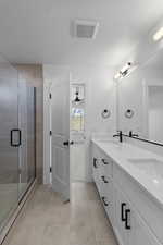 Full bathroom with double vanity, a stall shower, a ceiling fan, and light tile patterned flooring