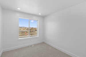 Carpeted spare room featuring a mountain view and recessed lighting
