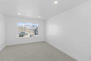 Empty room featuring carpet floors and recessed lighting