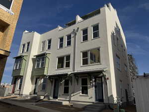 View of front of home featuring stucco siding, a standing seam roof, and a metal roof
