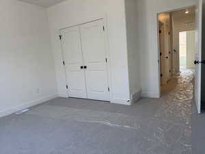 Unfurnished bedroom with a closet and baseboards