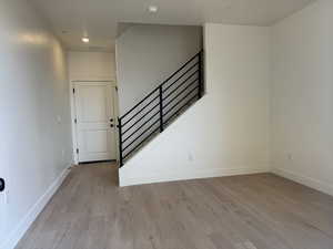 Staircase featuring wood finished floors and baseboards