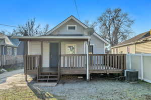 Rear view of property featuring a shingled roof and a porch