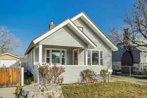 Bungalow-style house with a porch and a chimney