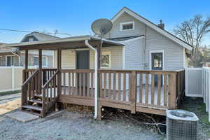 Back of house featuring a deck and a chimney