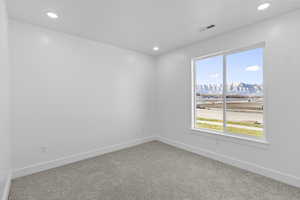 Carpeted empty room featuring a mountain view and recessed lighting