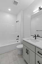Full bathroom with vanity, shower / bathtub combination, and light tile patterned floors