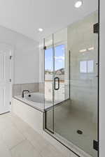 Full bathroom with a stall shower, light tile patterned flooring, a garden tub, and recessed lighting