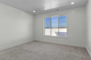 Unfurnished room featuring light carpet and recessed lighting