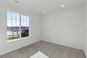 Empty room featuring carpet and recessed lighting