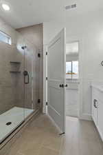 Bathroom with vanity, a stall shower, light tile patterned floors, and light colored carpet
