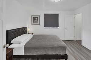 Bedroom featuring wood finished floors and a textured ceiling
