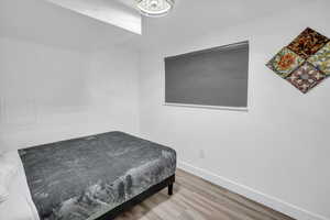Bedroom featuring baseboards and light wood-style floors