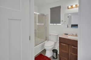 Full bath with vanity and enclosed tub / shower combo