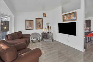 Living room featuring lofted ceiling