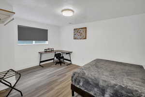 Bedroom featuring a textured ceiling and light wood-style flooring