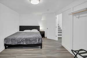 Bedroom featuring a textured ceiling and light wood-type flooring
