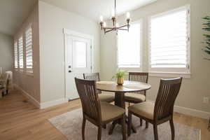 Dining room with a chandelier and light wood-type flooring