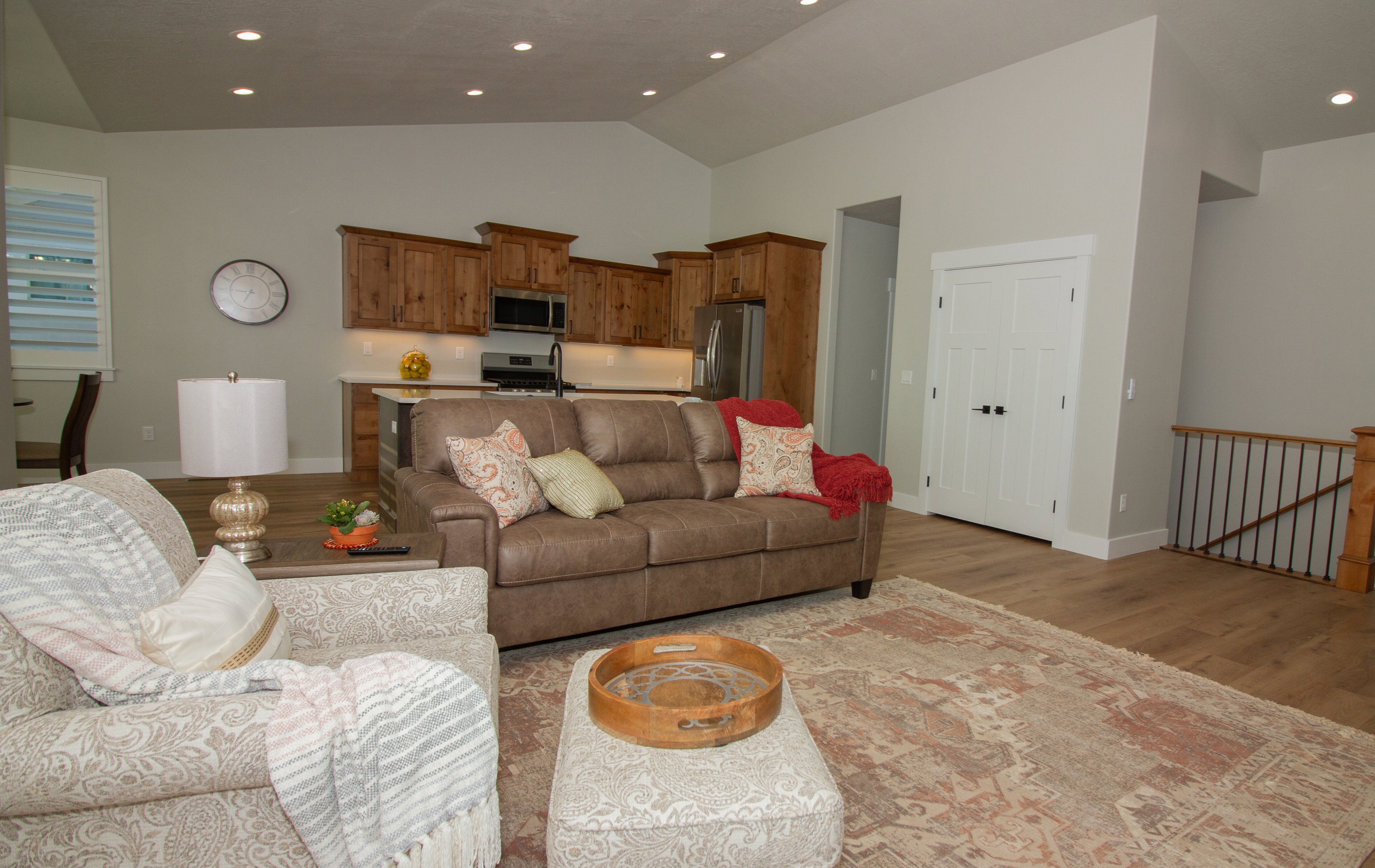 Living room featuring light wood-type flooring, recessed lighting, and high vaulted ceiling