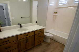 Second bathroom featuring vanity, shower / tub combination, and light wood-style floors