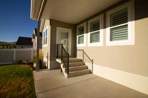 Entrance to property featuring stucco siding and a patio area