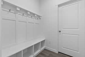 Mudroom with dark wood-style floors and baseboards