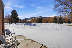 Yard covered in snow with a mountain view
