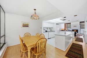 Dining space featuring light wood finished floors and a fireplace