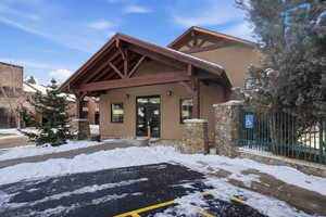 View of front facade with stucco siding and french doors
