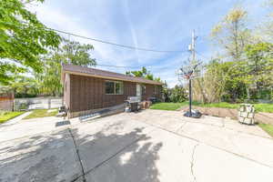 Back of the home with lots of space to entertain and kids to play