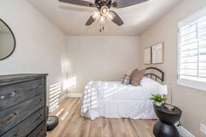 Bedroom featuring light wood finished floors and a ceiling fan