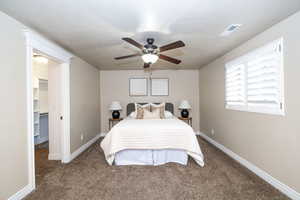 Bedroom featuring carpet flooring, a walk in closet, and ceiling fan