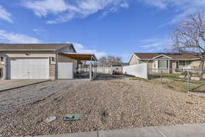 View of side of property with driveway and brick siding