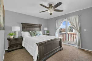 Bedroom with carpet floors, access to outside, and ceiling fan