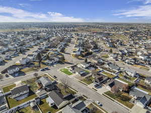 Aerial view of property and surrounding area with nearby suburban area