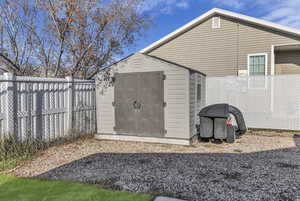 View of shed featuring a fenced backyard
