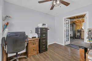 Office space with dark wood finished floors and ceiling fan