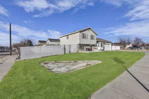 Rear view of house featuring a patio, brick siding, and a garage