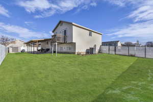 Back of house featuring a fenced backyard, a patio, and a storage shed