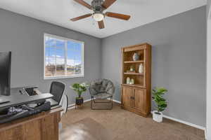 Office space featuring light carpet and ceiling fan